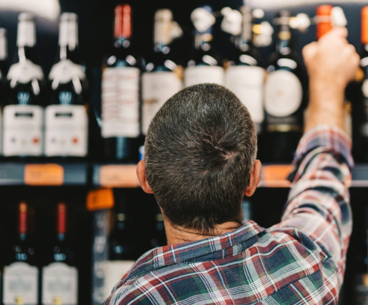 Man purchasing wine in a store